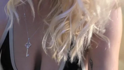 Blonde girl plays with herself on bed